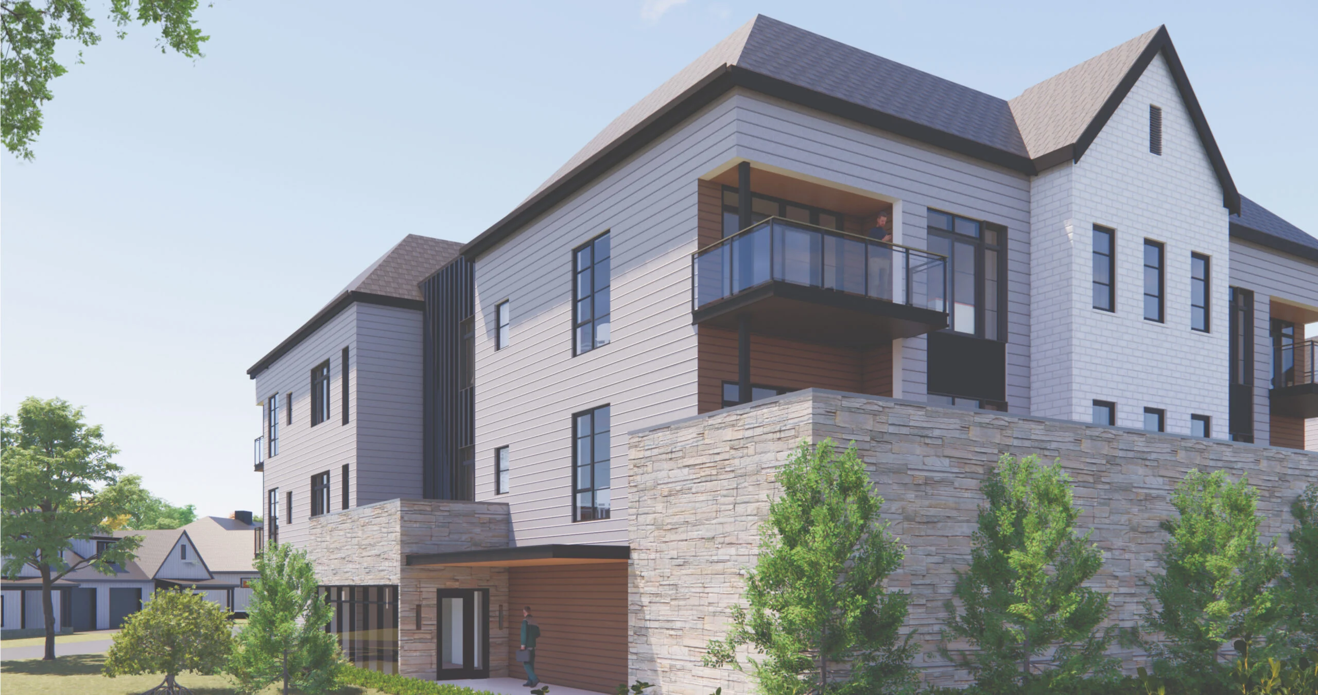 Exterior of a senior living community building with a balcony and landscaped greenery under clear skies.